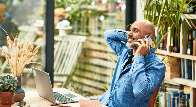Person working remotely from a home office overlooking Tucson desert landscape